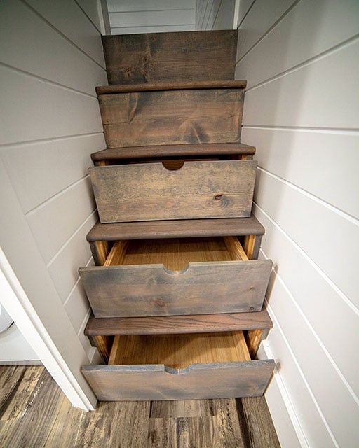 stairs in a tiny home are converted to drawers for extra storage